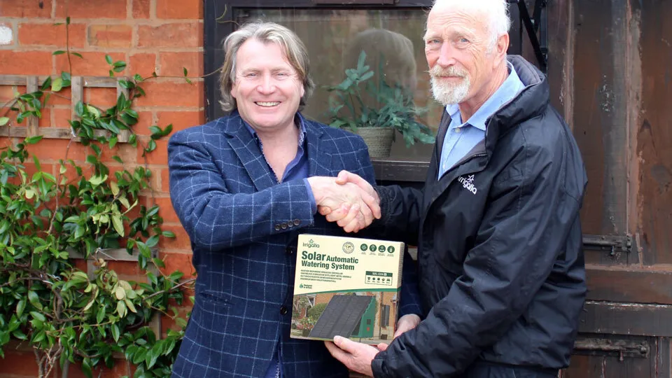 TV Gardener David Domoney and George Evans of Irrigatia shaking hands over an Irrigatia Solar Automatic Watering System