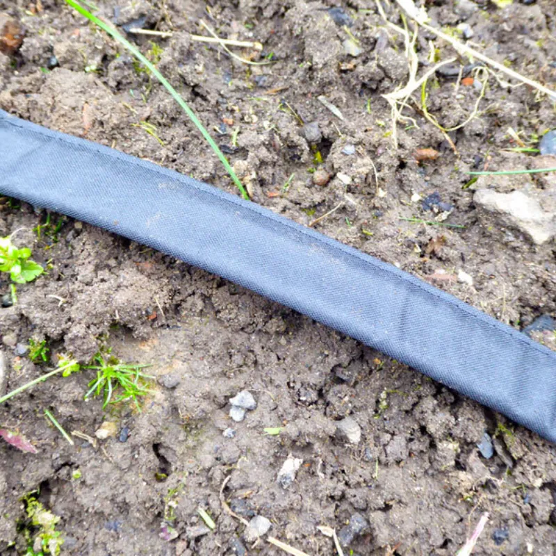Irrigation flat soaker hose shown on top of soil